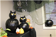 Two black cat figures made from two pumpkins each