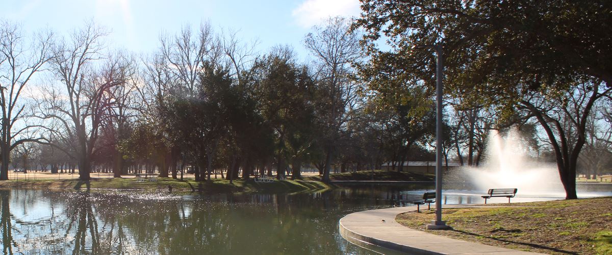 Riverside Park duck pond with a sidewalk along the edge