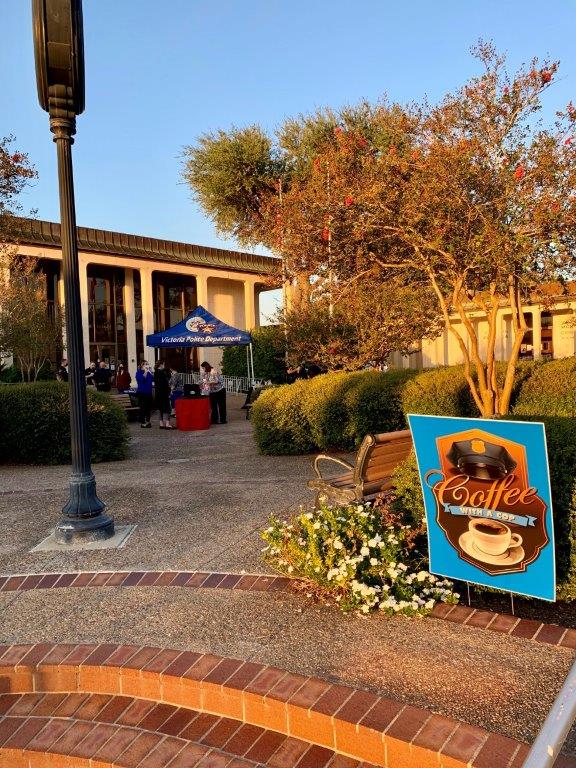 A sign in the City Hall courtyard advertises the Coffee with a Cop event.