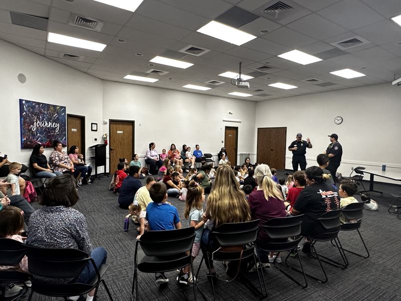 The Victoria Fire Department reading a story to children at the Victoria Public Library.
